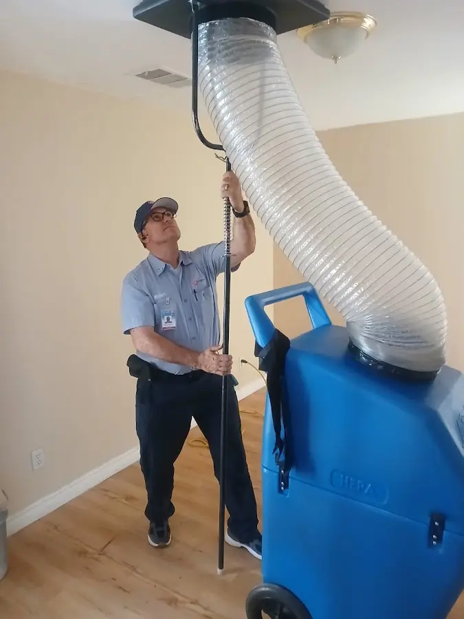 Furnace Tune-Up technician using HEPA equipment in Greer